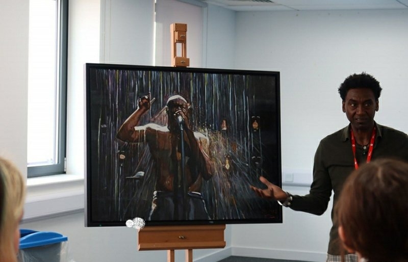 Damel Carayol by a painting of Stormzy